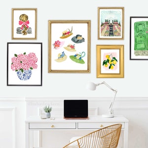 May include: A white wall gallery with six framed prints. The prints feature a woman with a bow in her hair, a bouquet of pink flowers, a collection of hats, a greenhouse, lemons on a branch, and a green door.