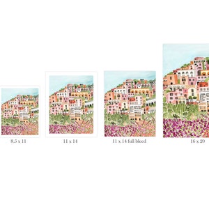 May include: Watercolor print of a coastal Italian village with colorful buildings cascading down a hillside. The artwork features pink, orange, and white buildings, with purple flowers in the foreground. Available in 5x7, 8.5x11, 11x14, and 16x20 inch sizes.