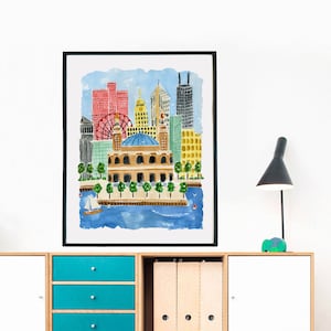 May include: A framed watercolor print depicting a city skyline with a prominent domed building in the foreground, a red Ferris wheel, and various skyscrapers in shades of red, yellow, and gray, set against a blue sky and water with a small sailboat.
