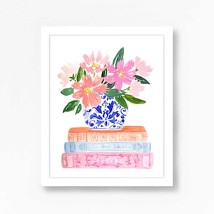 May include: A watercolor painting of a blue and white porcelain vase filled with pink and peach flowers. The vase is sitting on a stack of three books with colorful covers.