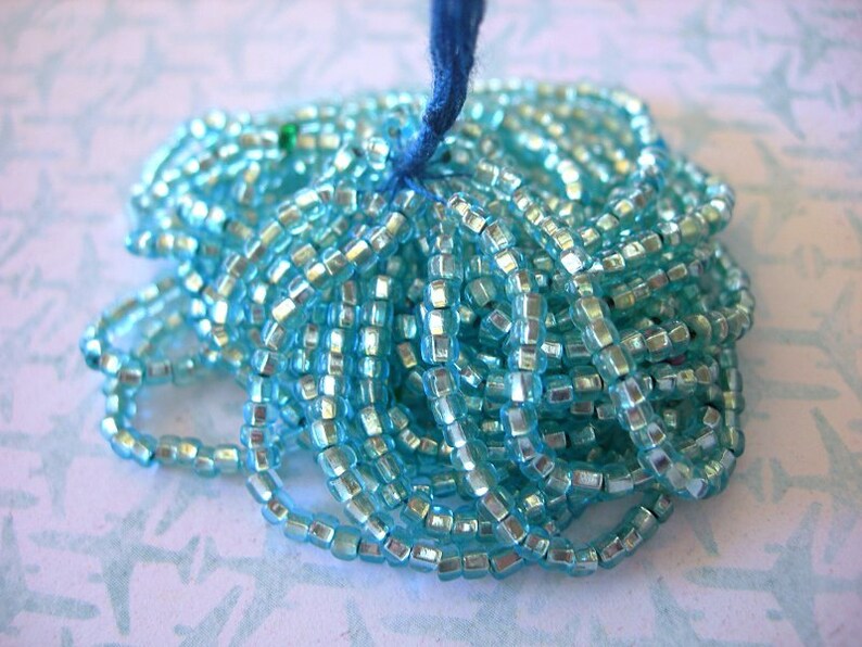 1 STRAND 8//0 TRANSPARENT AQUAMARINE FARFALLE SEED BEADS