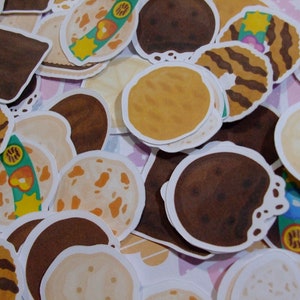 Pu&ograve; includere: Assortimento di adesivi rotondi, colorati e con motivi di biscotti. Gli adesivi presentano vari disegni, tra cui strisce, pois e motivi floreali. Gli adesivi sono perfetti per aggiungere un tocco di fantasia a qualsiasi progetto.