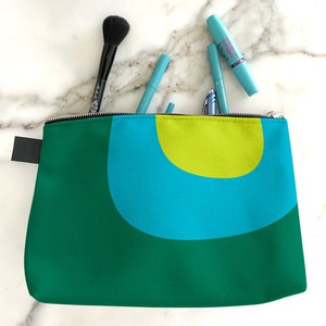 Retro cosmetics bag. A green and blue makeup bag with mid century, abstract print for cosmetics, toiletries, or accessories. Travel set image 2
