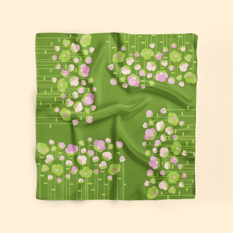 May include: Green silk scarf with a floral pattern of pink and green flowers. The flowers are arranged in a repeating pattern on a green background.