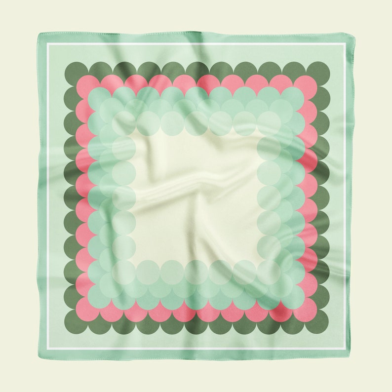 May include: A green and pink patterned square scarf with a white border. The pattern features a series of overlapping circles in shades of green and pink.