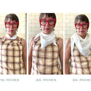 May include: Three images showing a person wearing a white square scarf tied in a knot at the neck. The scarf is shown in three different sizes: 16 inches, 26 inches, and 36 inches. The person is wearing a yellow and brown checked shirt and red glasses.