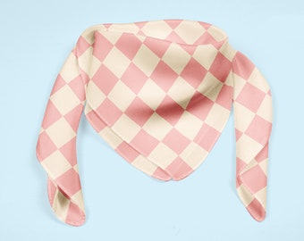 May include: A pink and white checkered bandana with a pointed tip. The bandana is made of a soft, silky fabric.