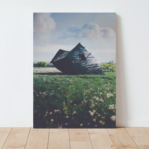 May include: A weathered wooden barn leans precariously on a grassy field. The barn has a large hole in the side and is surrounded by wildflowers.