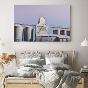 May include: A vintage photograph of a grain elevator with the text "Western Mark Grain Co. Dunkirk" on the side. The photo has a faded, vintage look and is printed on a canvas.