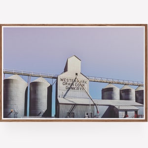 May include: A vintage photograph of a grain elevator with the text "Westernark Grain Corp. Dunkirk" on the side. The building is made of metal and has a series of silos.
