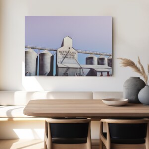 May include: A photograph of a vintage grain elevator with the text "Western Mark Grain Co. Dunkirk" on the side. The building is painted white with a light blue sky in the background.