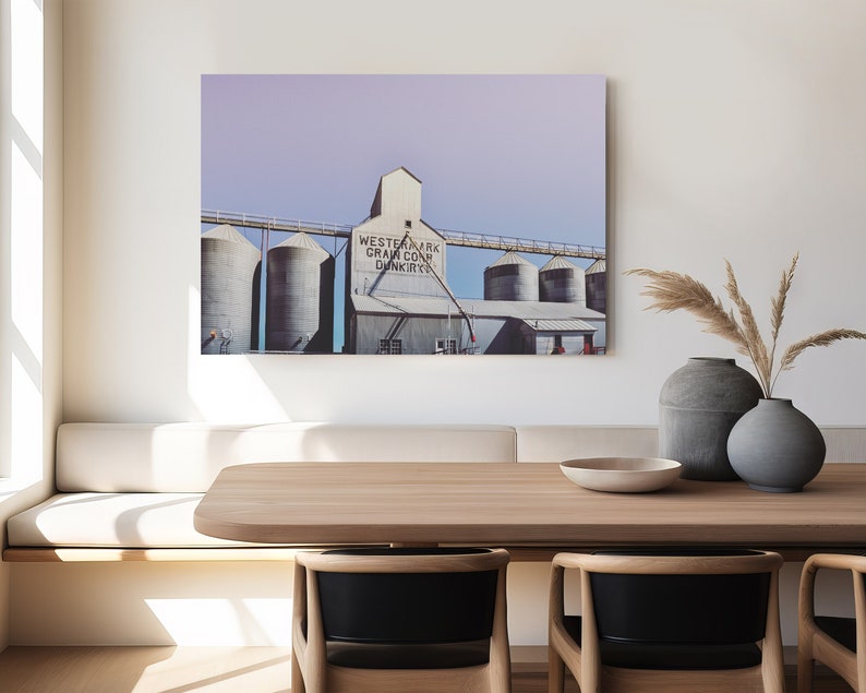 May include: A photograph of a vintage grain elevator with the text "Western Mark Grain Co. Dunkirk" on the side. The building is painted white with a light blue sky in the background.