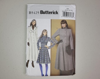 Può includere: Cartamodello Butterick B5425 con illustrazioni di tre varianti di cappotto. I modelli includono un cappotto lungo bianco, un cappotto al ginocchio con motivo pied-de-poule blu e bianco e un cappotto lungo grigio, tutti con chiusure a bottoni.