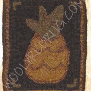 May include: A square, hand-hooked rug featuring a pineapple design. The pineapple is in shades of brown and tan, set against a dark background. The rug has a brown border with corner accents and the text "WOOLYREDRUG.COM".