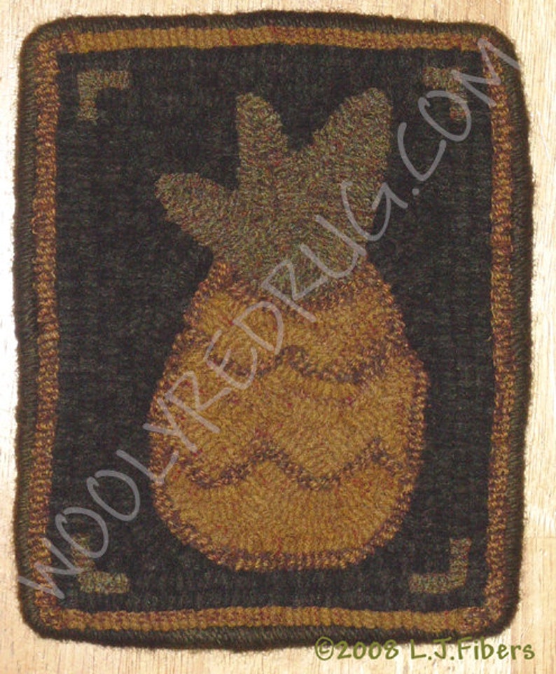 May include: A square, hand-hooked rug featuring a pineapple design. The pineapple is in shades of brown and tan, set against a dark background. The rug has a brown border with corner accents and the text "WOOLYREDRUG.COM".