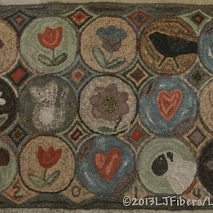 May include: Hand-hooked rug with a repeating pattern of circular designs. Each circle features a different image, including a mouse, flowers, a bird, and hearts. The rug has a neutral color palette with a dark border and the text "©2013 LJ Fibers/LLausen".