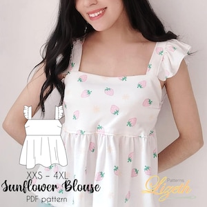 Puede incluir: Blusa blanca con estampado de fresas rosas y mangas con volantes. El texto "Sunflower Blouse" se muestra con información de tallas. Se muestra un patrón PDF en la imagen.