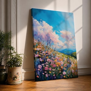 A vibrant impasto painting of a wildflower meadow featuring dense clusters of colorful flowers under a bright blue sky with fluffy clouds. The textured brushstrokes create depth and movement, capturing a lively natural landscape scene with rolling hills in the distance.