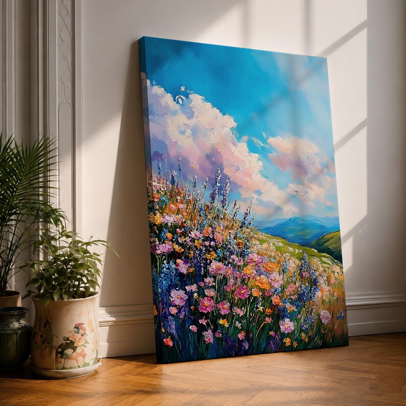A vibrant impasto painting of a wildflower meadow featuring dense clusters of colorful flowers under a bright blue sky with fluffy clouds. The textured brushstrokes create depth and movement, capturing a lively natural landscape scene with rolling hills in the distance.