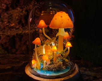 May include: A glass dome with a wooden base containing a miniature forest scene with glowing orange mushrooms and a blue water feature.