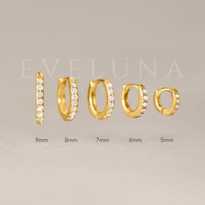 May include: Five gold-colored hoop earrings of varying sizes, each encrusted with small, clear gemstones. The earrings range in size from 5mm to 9mm. The brand name "EVELUNA" is displayed in the background.