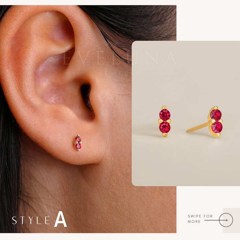 May include: A pair of gold earrings with two red gemstones each. The earrings are shown on a model's ear. The text "STYLE A" is visible in the image.