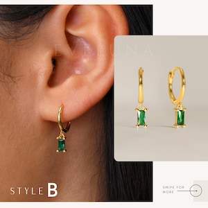 May include: Gold-colored hoop earrings with a rectangular, emerald-green gemstone pendant. The earrings are shown on an ear and also displayed separately. The text "STYLE B" is at the bottom left.