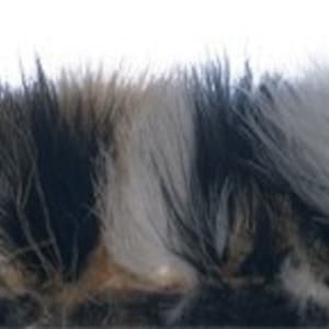 May include: A close-up of a strip of faux fur with alternating sections of black, brown, white, and grey fur.