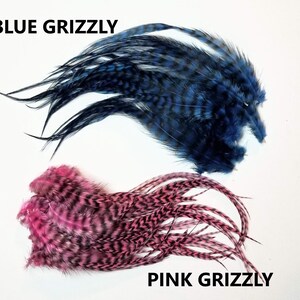 May include: Two bundles of feathers, one blue and one pink, with the text "BLUE GRIZZLY" and "PINK GRIZZLY" below each bundle.