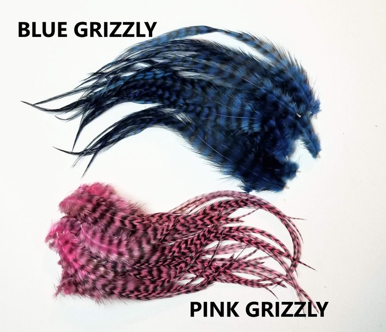 May include: Two bundles of feathers, one blue and one pink, with the text "BLUE GRIZZLY" and "PINK GRIZZLY" below each bundle.