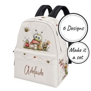 May include: A white backpack with black straps featuring a cartoon illustration of a ladybug, a caterpillar, and a bee near a mushroom. The name Adelaide is printed in brown script on the front pocket. Two circular badges read 6 Designs and Make it a set.