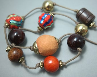 Long length wood, brass and foiled glass brown glass bead costume necklace