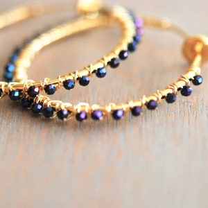 Gold tone clip on hoops with blue pyrite