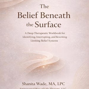 May include: A book cover with a soft, neutral color palette. The title "The Belief Beneath the Surface" is prominently displayed. The cover also includes the author's name, Shanita Wade, and the subtitle "A Deep Therapeutic Workbook".