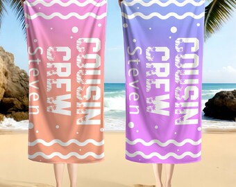May include: Two beach towels, one pink and orange, the other purple and lavender, are held up against a beach backdrop. Each towel features the text "COUSIN CREW Steven" in white, with a wavy border and palm tree accents.