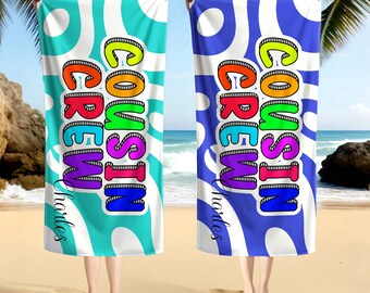 May include: Two beach towels with the text "COUSIN CREW" in rainbow colors. One towel is turquoise with white circles, the other is blue with white circles. The name "Charles" is written in cursive.