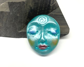 Smaller Art Doll Face Cabochon in turquoise blue pearlescence with symbolic spiral - handmade