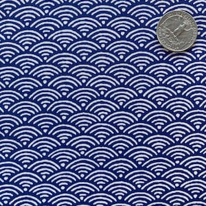 May include: A blue fabric with a white repeating pattern of overlapping semi-circles. The pattern resembles scales or waves.
