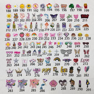 May include: A collection of colorful, decorative patches with various designs, including flowers, animals, food items, and text. The patches are numbered from 188 to 291 and are suitable for clothing or accessories.