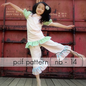 May include: A girl in a floral pajama set with green and blue frills. The top has short sleeves and the trousers are cropped. The image includes the text "pdf pattern nb-14".
