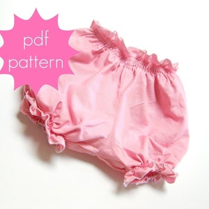 May include: Pink bloomers with ruffled edges and elastic waist. The text "pdf pattern" is displayed in a pink starburst shape. These bloomers are likely for babies or toddlers.