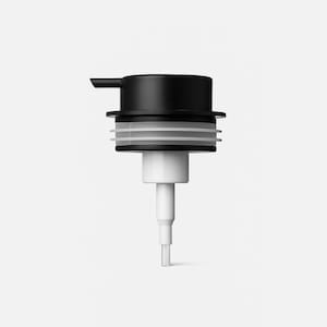May include: A black and white liquid dispenser pump. The top is black with a small spout, and the middle section has white and clear rings. The bottom part is white and cylindrical, with a narrow tip.