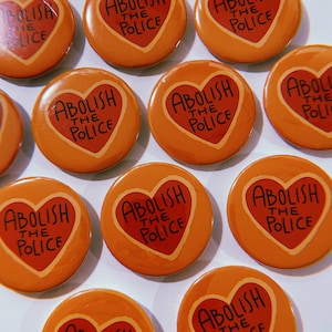Yellow and red abolish the police pinback button that makes a great gift or sticking stuffer for teens, men, millennials, and activists