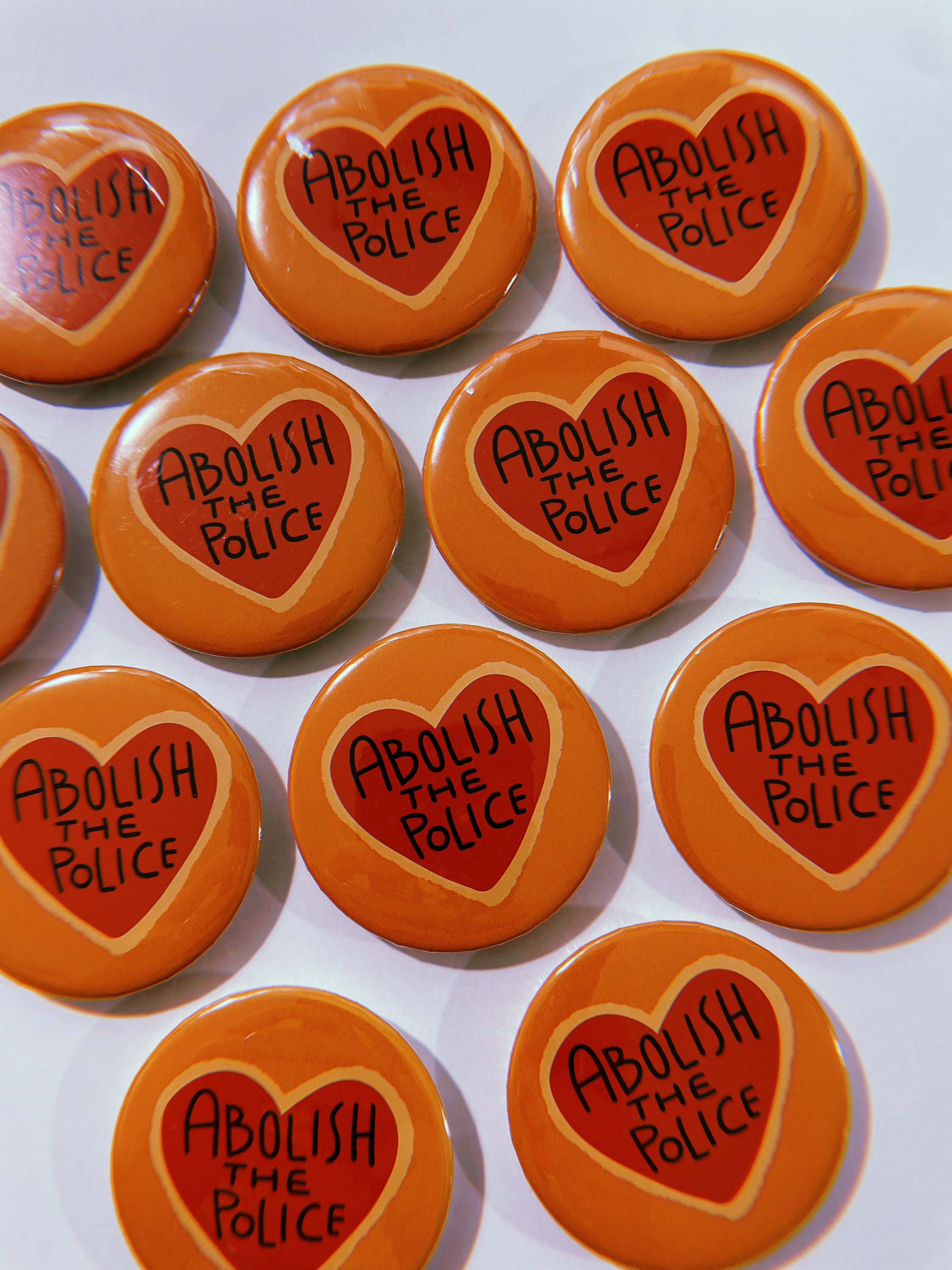 Yellow and red abolish the police pinback button that makes a great gift or sticking stuffer for teens, men, millennials, and activists