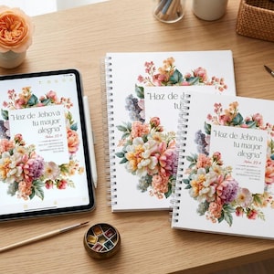 May include: A tablet and two spiral-bound notebooks featuring a floral design with pink, orange, and purple flowers. The text on each reads, "Haz de Jehová tu mayor alegría" and "Salmo 37:4". A paintbrush and a small paint palette are also visible.