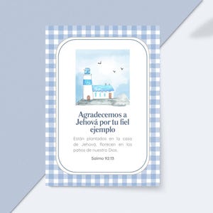 May include: A watercolour illustration of a lighthouse and small house on a greeting card. The card has a blue and white gingham border and text in Spanish. The text reads "Agradecemos a Jehová por tu fiel ejemplo".
