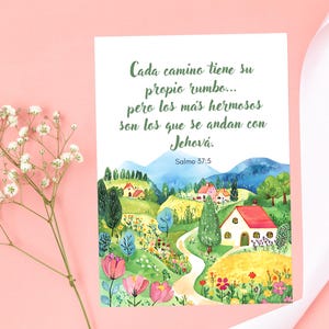 May include: A watercolor print featuring a scenic landscape with rolling hills, houses, and colorful flowers. The text in Spanish reads, "Cada camino tiene su propio rumbo... pero los más hermosos son los que se andan con Jehová. Salmo 37:5."