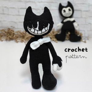 May include: Black and white crochet amigurumi toy of Bendy from the video game Bendy and the Ink Machine. The toy has a white bow tie and a wide grin. The text "crochet pattern" is written in black on a white background.