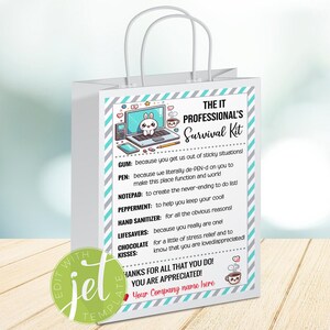 May include: A white gift bag with a blue and gray design. The bag has a handle and says "The IT Professional's Survival Kit" on the front. The bag includes a list of items with descriptions, such as gum, pen, notepad, peppermint, hand sanitizer, lifesavers, chocolate, and kisses.