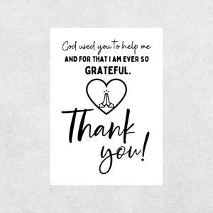 May include: A white card with black text. The text reads "God used you to help me AND FOR THAT I AM EVER SO GRATEFUL." A heart with praying hands is in the center, and below it, "Thank you!" is written in a script font.